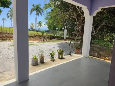 a porch with potted plants and a ladder at Hermosa casa de campo in Juana Vicenta