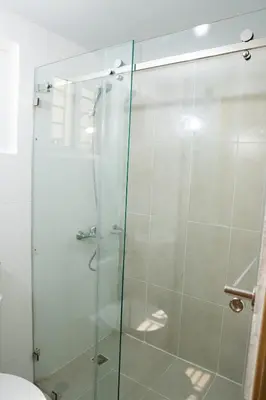 a shower with a glass door in a bathroom at vacation apartment BANI PERAVIA in Boca Canasta