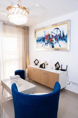 a dining room with blue chairs and a table at vacation apartment BANI PERAVIA in Boca Canasta