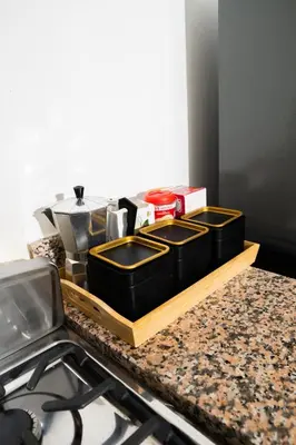 a kitchen counter with two black containers on a cutting board at vacation apartment BANI PERAVIA in Boca Canasta