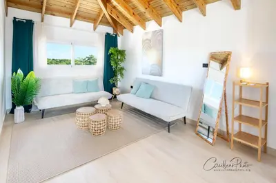 a living room with a couch and a table at Estrella Garden Shaula 301 New Modern Penthouse in La Laguna
