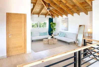 a living room with a wooden door and a couch at Estrella Garden Shaula 301 New Modern Penthouse in La Laguna