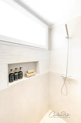 a bathroom with a shower niche with three bottles of soap at Estrella Garden Shaula 304 New Modern Penthouse in La Laguna