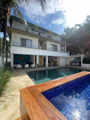 a house with a swimming pool in front of a house at Villa Mirna in Las Terrenas