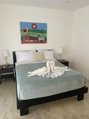 a bedroom with a bed with a towel on it at Villa Mirna in Las Terrenas