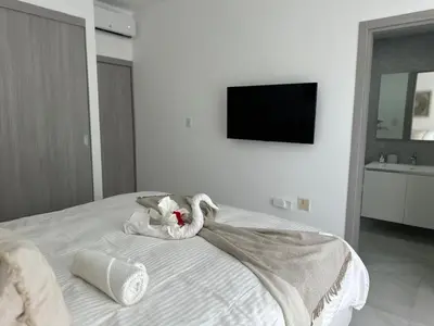 a bedroom with a bed with towel animals on it at A104 - PRADOS · Peaceful 2BR Poolside Retreat • Punta Cana Getaway in Punta Cana