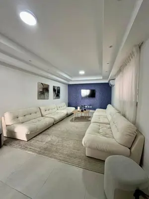 a large living room with white couches and a table at Moderno 1 Habitación Cerca Avenida Churchill in Santo Domingo