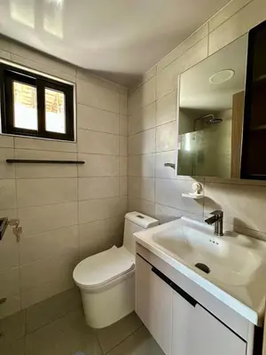 a bathroom with a white toilet and a sink at Moderno 1 Habitación Cerca Avenida Churchill in Santo Domingo