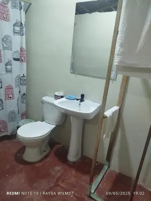 a bathroom with a toilet and a sink at Parador tropical Raysa in Las Galeras