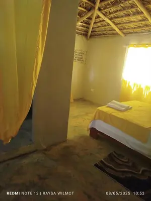 a room with a bed and a window at Parador tropical Raysa in Las Galeras