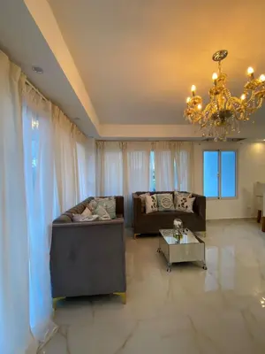 a living room with a couch and a chandelier at A space designed for you in San Cristóbal