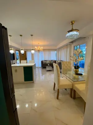 a kitchen and living room with a table and a couch at A space designed for you in San Cristóbal
