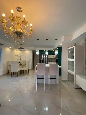 a dining room and kitchen with a chandelier at A space designed for you in San Cristóbal