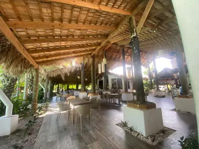 a restaurant with tables and chairs and a wooden ceiling at A space designed for you in San Cristóbal
