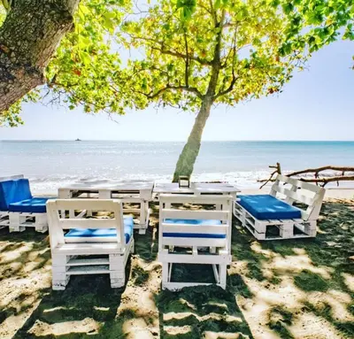 a group of chairs and tables on the beach at A space designed for you in San Cristóbal