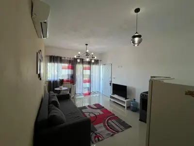 a living room with a couch and a tv at Quiet and beautiful view in Boca Chica