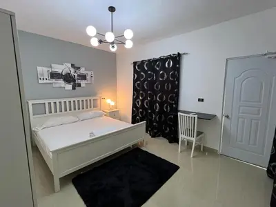 a bedroom with a bed and a table and a chair at Quiet and beautiful view in Boca Chica