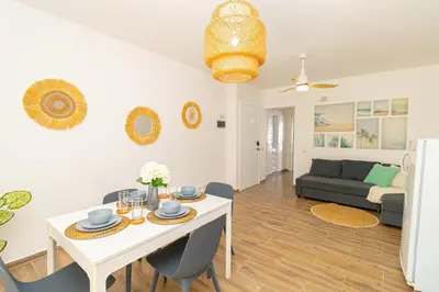 a living room with a white table and a couch at Luxury 1 BR at Paraiso Residence Bayahibe in Bayahibe