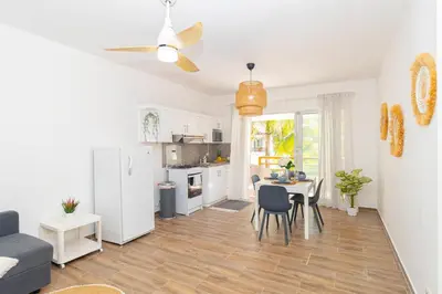 a kitchen and living room with a table and chairs at Luxury 1 BR at Paraiso Residence Bayahibe in Bayahibe