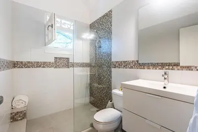a bathroom with a toilet and a sink and a shower at Galeria Beach Front, Top floor in Sosúa