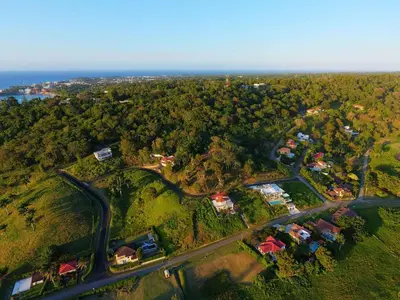an aerial view of a village with a road at Villa real con piscina panorámica para más de 14 huéspedes in Sosúa