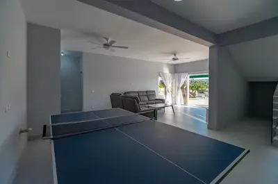 a living room with a ping pong table in it at Villa real con piscina panorámica para más de 14 huéspedes in Sosúa