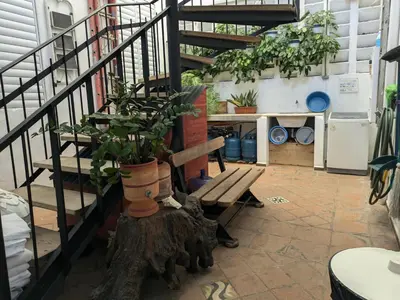 a room with a staircase and a bench with plants at Espacio Santa Bárbara, Zona Colonial in Santo Domingo
