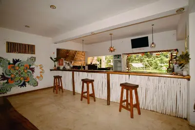 a kitchen with a bar with stools in it at Ganesh Village Community in Colorado
