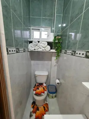 a bathroom with a toilet with a flower design on the floor at Playa y arena in San Felipe de Puerto Plata