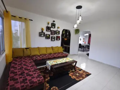 a living room with a couch and a table at Brisa de mar in San Felipe de Puerto Plata