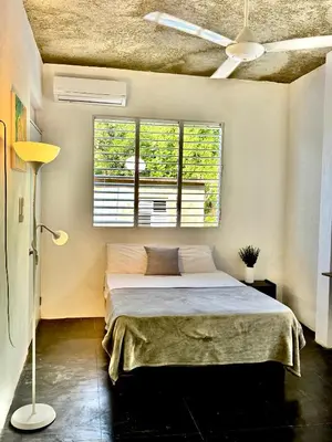 a bedroom with a bed and a window at Hostal Luz Del Valle in Santa Bárbara de Samaná