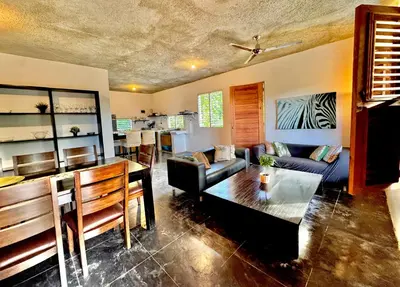 a living room with a couch and a table at Hostal Luz Del Valle in Santa Bárbara de Samaná