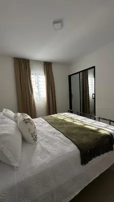 a bedroom with a large bed and a large mirror at Apartamento en La Romana 3 habitaciones in La Romana