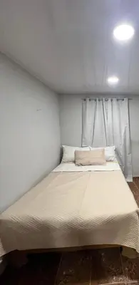a large bed in a room with white walls at La Casita in Vicente Noble