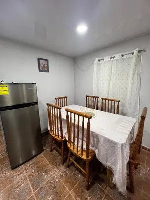 a dining room with a table and a refrigerator at La Casita in Vicente Noble