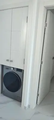 a microwave in a room with white cabinets at Penthouse in Cana Rock in Punta Cana