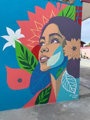 a mural of a woman with flowers on a wall at Terra Mia Villa in Pedernales