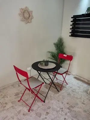 a table and two chairs in a room at Private and comfortable double room in Santo Domingo