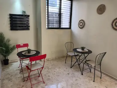 two tables and four chairs in a room at Private and comfortable double room in Santo Domingo