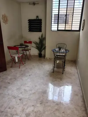 a room with two tables and chairs and a window at Private and comfortable double room in Santo Domingo