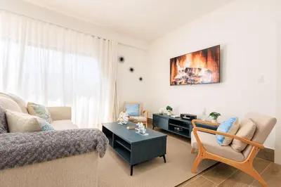 a living room with a couch and a table at Cozy 2BD Condo, Near Beach in San Felipe de Puerto Plata