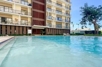 a large swimming pool in front of a building at Cozy 2BD Condo, Near Beach in San Felipe de Puerto Plata