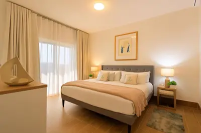 a bedroom with a bed and a large window at Cozy 2BD Condo, Near Beach in San Felipe de Puerto Plata