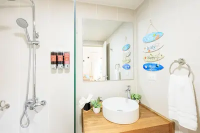 a bathroom with a sink and a shower at Cozy 2BD Condo, Near Beach in San Felipe de Puerto Plata