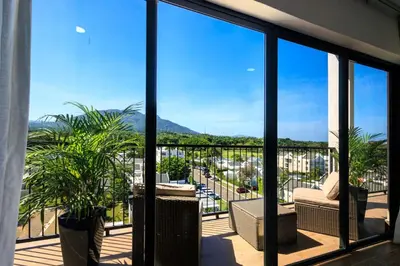 a balcony with a view of a city at Cozy 2BD Condo, Near Beach in San Felipe de Puerto Plata