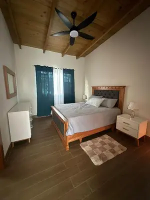 a bedroom with a bed and a ceiling fan at Bello atardecer in Punta Cana