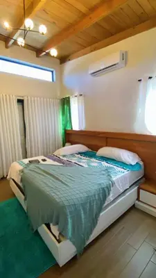 a bedroom with a bed with a wooden headboard at Bello atardecer in Punta Cana