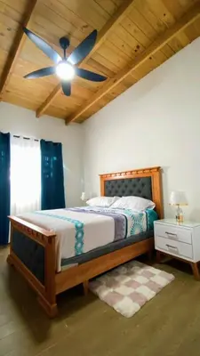 a bedroom with a bed with a ceiling fan at Bello atardecer in Punta Cana