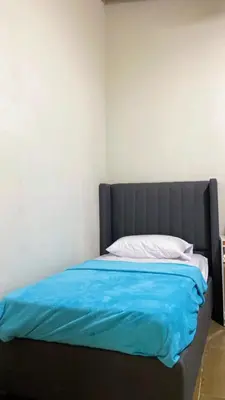 a bed with a blue comforter in a bedroom at Bello atardecer in Punta Cana