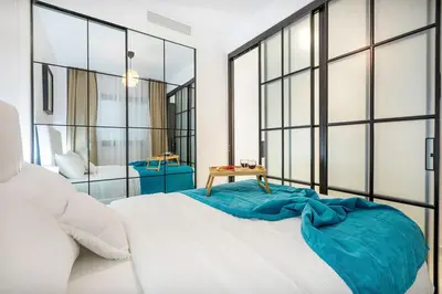 a bedroom with a large bed with a blue blanket on it at Couples PH @ Cana Rock Star with Great Golf Views in Punta Cana